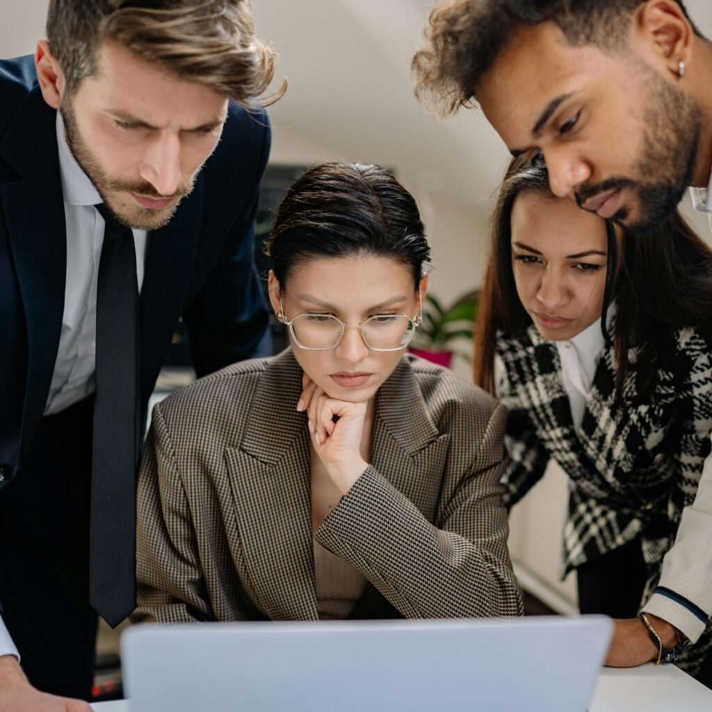 Group of People Looking at a Laptop