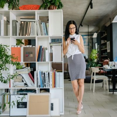 A Woman in White Top and Gray Skirt Inside an Office